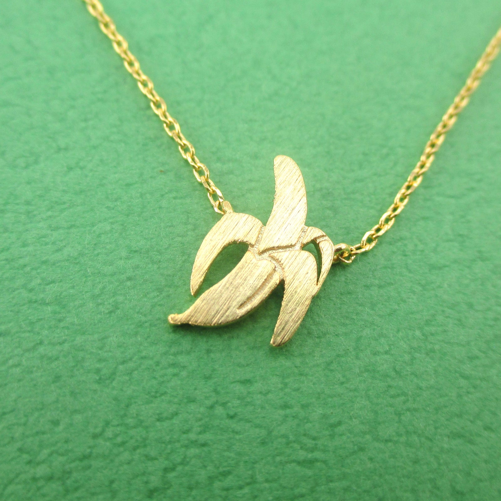Peeled Banana Shaped Food Themed Pendant Necklace in Gold — shop and try on with AI characters